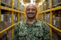 USNS Mercy Sailor Inventories Supplies 200424-N-PH222-1070 LOS ANGELES (April 24, 2020) Logistics Specialist 1st Class Ernesto Mendoza, from Lynwood, Calif., poses for a photo in the warehouse aboard the hospital ship USNS Mercy (T-AH 19).