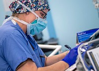 200430-N-PH222-1448 LOS ANGELES (April 30, 2020) Capt. Lana Clouser, from Minot, N.D., records patient information prior to surgery in an operating room aboard the hospital ship USNS Mercy (T-AH 19).