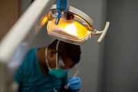 200501-N-LW757-4020 LOS ANGELES (May 1, 2020) Hospital Corpsman 1st Class Leonard Currie, from Los Angeles, performs a dental assessment aboard the hospital ship USNS Mercy (T-AH 19) May 1. Mercy deployed in support of the nation's COVID-19 response efforts, and serves as a referral hospital for non-COVID-19 patients currently admitted to shore-based hospitals.