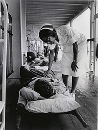 South China Sea. A Navy nurse aboard the hospital ship USS Repose (AH-0016) offers a word of encouragement to a patient who is ready for departure for the United States for further treatment.