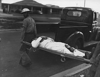 Sailor injured during Jap attack on Pearl Harbor is carried to safety. December 7, 1941. BUAER 77625 Navy Medicine Historical Collection - Facilities - Pearl Harbor. Original public domain image from Flickr