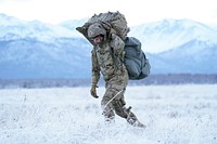 Army Pfc. Evan Samuel, assigned to the 2nd Battalion, 377th Parachute Field Artillery Regiment, 4th Infantry Brigade Combat Team (Airborne), 25th Infantry Division, U.S. Army Alaska, makes his way to a rally point after conducting a parachute jump on Malemute drop zone at Joint Base Elmendorf-Richardson, Alaska, Dec. 11, 2019. The Soldiers are part of the Army’s only Pacific airborne brigade with the ability to rapidly deploy worldwide, and are trained to conduct military operations in austere conditions. (U.S. Air Force photo/Justin Connaher). Original public domain image from Flickr