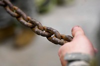 A soldier assigned to the 109th Transportation Company, 17th Combat Sustainment Support Battalion, U.S. Army Alaska, holds a chain to steady a damaged engine from an M984A2 Heavy Expanded Mobility Tactical Truck wrecker as it’s hoisted onto jack stands in his unit’s motor pool on Joint Base Elmendorf-Richardson, Alaska, Dec. 13, 2019. The M984A2 is an eight-wheel drive, diesel-powered, variant of the HEMTT used in vehicle recovery operations. (U.S. Air Force photo/Justin Connaher). Original public domain image from Flickr