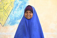 A grade one student poses for a photograph during break time outside of her class at Mohamud Hilowle Primary and Secondary School in Wadajir district, Mogadishu, Somalia on 12 January 2020. AMISOM Photo / Ilyas Ahmed. Original public domain image from Flickr