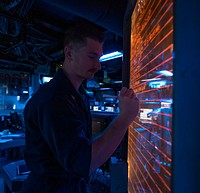 MEDITERRANEAN SEA (Oct. 7, 2020) Operations Specialist 2nd Class Wyatt Crump adds to the plan of the day in the combat information center aboard Arleigh Burke-class guided-missile destroyer USS Roosevelt (DDG 80), Oct. 7, 2020.