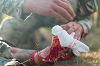 A Soldier with the 32nd Georgia Infantry Battalion treats a simulated amputee injury during the Mission Rehearsal Exercise at Vaziani Training Area Georgia, Oct. 19, 2020.