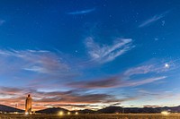 While the comet Neowise was obscured by cloud cover, photojournalist Randy Montoya took this nighttime photo of Sandia Labs&rsquo; National Solar Thermal Test Facility in Albuquerque, NM. Venus illuminates the cloud at right. Original public domain image from Flickr