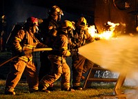 Firefighters conduct a firefighting demonstration during Fire Prevention Week at Naval Station Guantanamo Bay, Cuba, Oct. 7, 2010.