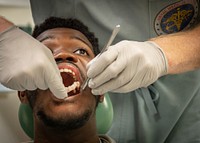 Patient’s prosthetic denture and oral cavity are inspected in Naval Medical Center San Diego’s (NMCSD) Dental Department approximately six weeks after an immediate jaw replacement surgery.