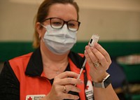 NAVAL AIR STATION SIGONELLA, ITALY (Jan. 9, 2021)-- Angeline Mitchell, registered nurse and American Red Cross volunteer, prepares shots of the Moderna COVID-19 vaccine for the inoculations of critical medical staff and first responder volunteers onboard Naval Air Station (NAS) Sigonella, Jan. 9, 2021.