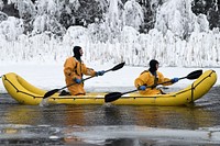 From left, U.S. Air Force Staff Sgt. James Posey and U.S. Air Force Airman 1st Class Dustin Williamson, both fire protection specialists assigned to the 673d Civil Engineer Squadron, use an inflatable raft to recover a simulated cold-water victim during ice rescue training at Six Mile Lake on Joint Base Elmendorf-Richardson, Alaska, Dec. 21, 2020. The training certified the firefighters as ice rescue technicians by providing them with the knowledge and skills necessary for safe rescue and recovery operations in ice and cold water. (U.S. Air Force photo by Airman 1st Class Emily Farnsworth). Original public domain image from Flickr