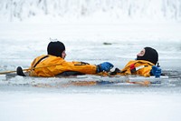 JBER fire protection specialists conduct ice rescue trainingU.S. Air Force Staff Sgt. James Posey, left, and Airman 1st Class Stefan Walter, fire protection specialists with the 673d Civil Engineer Squadron, practice rescue and recovery techniques during ice rescue training at Six Mile Lake on Joint Base Elmendorf-Richardson, Alaska, Dec. 21, 2020. The training taught the JBER firefighters the knowledge and skills necessary for safe rescue and recovery operations in, on, and around the ice and cold water. Upon completing a classroom session, a practical skills evaluation, and a written examination, the fire protection specialists were certified as ice rescue technicians. Posey and Walter are from Crawfordville, Fla., and Portland, Ore., respectively. (U.S. Air Force photo by Alejandro Peña). Original public domain image from Flickr