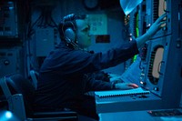 BLACK SEA (Feb. 3, 2021) Sonar Technician (Surface) 3rd Class Nicholas Llamas checks a console for acoustic readings aboard the Arleigh Burke-class guided-missile destroyer USS Donald Cook (DDG 75), Feb. 3, 2021.