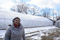 Aster Bekele, the founder of The Felege Hiywot Center in Indianapolis, Indiana, stand by the center's high tunnel that was built in November 2020 and will be planted for the first time in Spring 2021.