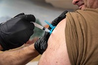 SOUDA BAY, Greece (Feb. 20, 2021) Cmdr. Christopher Petro, executive officer of the Arleigh Burke-class guided-missile destroyer USS Porter (DDG 78), receives the COVID-19 vaccine from Hospital Corpsman Kevin Gonzalez in Souda Bay, Greece, Feb. 20, 2021.