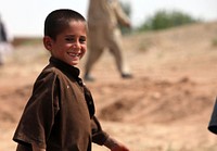 A local Afghan child greets Marines