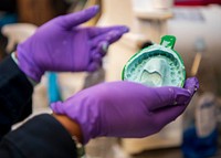 NEWPORT NEWS, Va. (Aug. 11, 2020) Hospital Corpsman 3rd Class Ellysse Tilley, assigned to the dental department aboard the Nimitz-class aircraft carrier USS George Washington (CVN 73), removes the alginate impression from her mouth in order to create a maxillary essix retainer.