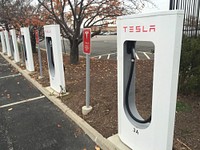 Electric car charging station located at Potomac Mills Mall in Woodbridge, VA. USDA photo by Ken Hmmond. Original public domain image from Flickr