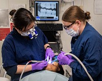 Blue Ridge Sailor Receives Dental Care 210413-N-DE082-2026 SAGAMI WAN, Japan (April 13, 2021) - Lt. Cmdr. Wei Liu, from Brooklyn, New York (left) and Hospital Corpsman 3rd Class Sara Closs, from Long Beach, New York, perform a procedure to correct a fractured tooth in the ship's dental clinic aboard U.S. 7th Fleet flagship USS Blue Ridge (LCC 19).