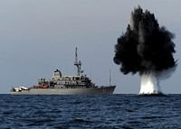 101119-N-6266K-023 STRAITS OF HORMUZ (Nov. 19, 2010) A demolition charge detonates 1,500 meters from Avenger-class mine countermeasures ship USS Scout (MCM 8).