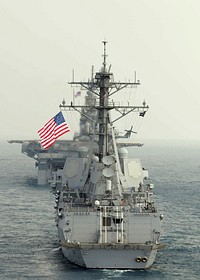 The guided missile destroyer USS Stockdale (DDG 106) maneuvers behind the amphibious assault ship USS Essex (LHD 2) during a Cobra Gold 2011 photo exercise in the Gulf of Thailand Feb. 14, 2011.