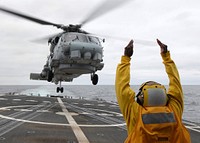 110711-N-ZI300-135 PACIFIC OCEAN (July 11, 2011) A landing signal enlisted (LSE) signals to the pilots of an SH-60B Sea Hawk helicopter taking off from guided-missile frigate USS Thach (FFG 43).