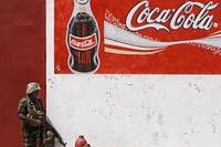 A Ugandan soldier serving with the African Union Mission in Somalia (AMISOM) takes up a defensive position outside the old Coca-Cola factory in northern Mogadishu.