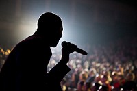 A U.S. Airman assigned to the Tops in Blue sings during a performance at the North Charleston Performing Arts Center, S.C., Feb. 8, 2012. (DoD photo by Airman 1st Class George Goslin, U.S. Air Force/Released). Original public domain image from Flickr