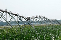 A U.S. Department of Agriculture (USDA) Natural Resources Conservation Service (NRCS) employee examines the control box of a center pivot irrigation system on a Delaware farm on July 8, 2008.