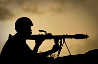 A Ugandan soldier of 341 Battalion serving with the African Union Mission in Somalia (AMISOM) holds a rocket-propelled grenade at sunrise 30 April 2012, on the frontline near the main road on the northern edge of Maslah Town, the northern city limit of the Somali capital Mogadishu.