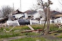 Houses were crushed and swept off their foundations by the flooding from a breached levee in the Ninth Ward, New Orleans, LA, due to the 20-foot storm surge from Hurricane Katrina that overwhelmed the flood control system.