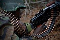 A soldier serving with the African Union Mission in Somalia (AMISOM) takes up a defensive position during a firefight 22 May, during a joint AMISOM and Somali National Army (SNA) operation to seize and liberate territory from the Al-Qaeda-affiliated extremist group Al Shabaab.