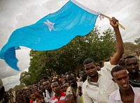 A man waves the Somali national flag ahead of the arrival of Somali President Sheik Sharif Sheik Ahmed (not seen) in Balad town in Middle Shabelle region approx.