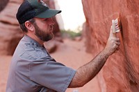 Stephen Allen removes graffiti. Credit: NPS/Andrew Kuhn. Original public domain image from Flickr