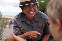 Diane Tom talks with a junior ranger. (NPS Photo by Andrew Kuhn). Original public domain image from Flickr