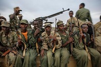 Fighters of the Ras Kimboni Brigade, a Somali government-allied militia are seen riding on the back of a machine-gun-mounted battle wagon as they join troops from the Kenyan Contingent of the African Union Mission in Somalia (AMISOM) ahead of an advance on the Somali port city of Kismayo.