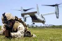 U.S. Marine Corps Lance Cpl. Andrew R. Becker provides landing zone security as an MV-22B Osprey touches down during training at the central training area in Okinawa, Japan, April 11, 2013.