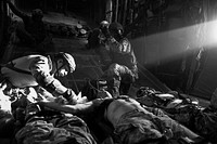 U.S. Airmen assigned to the 82nd Expeditionary Rescue Squadron provide medical care to simulated patients during a combat search and rescue exercise on board an MC-130P Combat Shadow aircraft over the Grand Bara Desert, Djibouti, May 12, 2013.