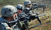 U.S> Army Cpl. Johnny Hurst, assigned to A Company 3rd Battalion (Airborne) 509th Infantry Regiment, yells a shift-fire command to his fire team during a live-fire and movement-to-contact operation on the Infantry Squad Battle Course at Joint Base Elmendorf-Richardson, Alaska, May 31, 2013. The soldiers focused on core infantry skills such as fire team movement, communication, shifting fire, and once on the objective identifying and eliminating weapons caches and treating and evacuating casualties. (DoD photo by Justin Connaher, U.S. Air Force/Released). Original public domain image from Flickr