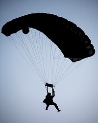 A U.S. Marine, with the 26th Marine Expeditionary Unit (MEU) Maritime Raid Force, descends to a landing zone while conducting parachute operations over Djibouti, Africa, May 27, 2013.