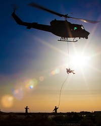 A U.S. Marine, top, with the 26th Marine Expeditionary Unit's Maritime Raid Force rappels from a UH-1N Iroquois helicopter assigned to Marine Medium Tiltrotor Squadron (VMM) 266 during a helicopter rope suspension technique exercise at King Faisal Air Base in Jordan June 11, 2013, during exercise Eager Lion 2013.