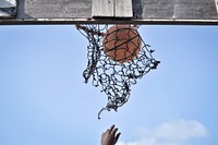A ball is shot through an old basketball net on a court in Mogadishu, Somalia. Original public domain image from <a href="https://www.flickr.com/photos/au_unistphotostream/9229549841/" target="_blank">Flickr</a>