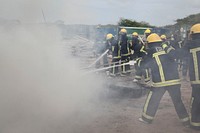 Somali firemen demonstrate their newly learned skills during an excercise attended by the Mayor of Mogadishu, Mohamed Nur, and AMISOM's Contingent Commander, Brigadier General Michael Ondoga, in Mogadishu on July 6. AU UN IST PHOTO / ABDI IYE. Original public domain image from Flickr