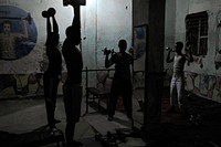 A group of weight lifters train together at a gym in the Hamar Weyne district of Mogadishu, Somalia, on August 12. AU UN IST PHOTO / TOBIN JONES. Original public domain image from <a href="https://www.flickr.com/photos/au_unistphotostream/9498439423/" target="_blank" rel="noopener noreferrer nofollow">Flickr</a>