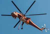 An Erickson Air-Crane's "Helitanker 737" Skycrane climbs into the sky after using a hose pump to fill it triangular shaped tank with water from the East Fork of Baker Creek, to fight the Beaver Creek Fire, northwest of Hailey, ID, on Tuesday, Aug 20, 2013.