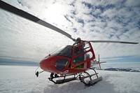 North South Polar's (NSP) safety team leader, John Bradley, boards an Air Greenland A-Star helicopter heading to a fuel cache on a remote island near Koge Bay, Greenland, Aug. 7, 2013.