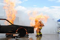 U.S. Air Force Senior Airman Christopher Crusius, a firefighter assigned to the 612th Air Base Squadron, is engulfed in flames as he opens the hood of a mock-up vehicle during a simulated car fire as part of Central America Sharing Mutual Operational Knowledge and Experiences (CENTAM SMOKE) Exercise at Soto Canto Air Base Honduras, Aug. 27, 2013.