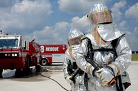 U.S. Air Force firefighters with the 169th Civil Engineer Squadron at McEntire Joint National Guard Base, South Carolina Air National Guard, respond to a scenario involving an incapacitated fighter pilot trapped in an F-16 Fighting Falcon fighter jet during a Certified Readiness Evaluation, Sept. 8, 2013.