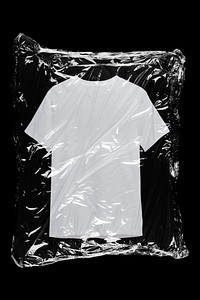 White t-shirt wrapped in plastic, black background