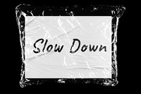 Slow down plastic covered handwritten message, black background